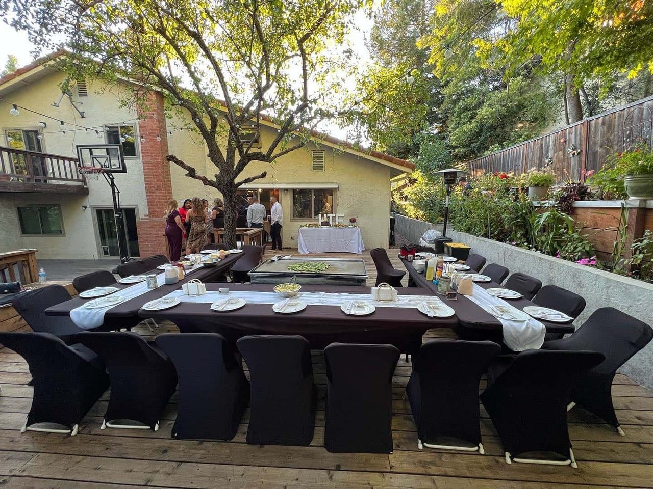 Backyard tables and chairs set up for a hibachi party